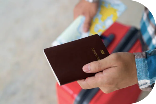 A traveler holding a passport and travel map